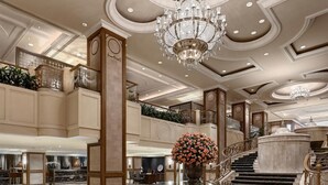 A grand lobby with a chandelier, a staircase, and a large floral arrangement. - The Langham Hotel, Melbourne (Melbourne)