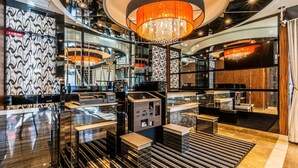 A modern lobby with a chandelier, patterned walls, and a check-in counter. - Apa Hotel A Namba Minami Ebisucho Ekia (Osaka)
