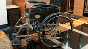 A wheelchair in a modern lobby with a marble floor and wooden paneling. - Apa Hotel A Namba Minami Ebisucho Ekia (Osaka)