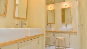 A bathroom with two sinks, mirrors, and wooden stools. - Almond Hostel And Cafe (Tokyo)