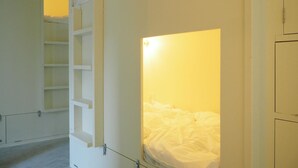 A room with a bunk bed, a ladder, and a shelf unit. - Almond Hostel And Cafe (Tokyo)