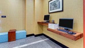 A reception area with two computer stations, a printer, and a sign indicating the business center. - Drury Inn Suites Phoenix Chandler Fashion Center (Phoenix)