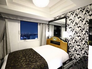 A hotel room with a large bed, a city view through a window, a mirror, and a patterned wall. - Apa Hotel Yamanote Otsukaeki Tower (Tokyo)