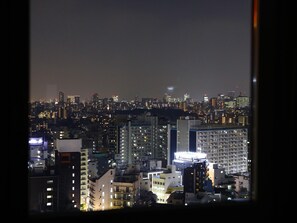 A nighttime cityscape with illuminated buildings and a prominent hotel sign. - Apa Hotel Yamanote Otsukaeki Tower (Tokyo)