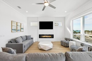 TV, fireplace, video games, table football - Brand New Luxe Home for Family Gatherings • Elevator • Gulf Views + Heated Pool (Panama City Beach)