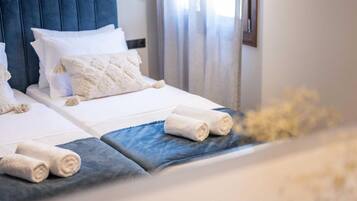 A hotel room with a bed, pillows, and towels.