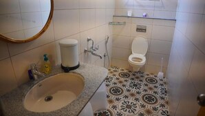 A bathroom with a sink, toilet, and shower.