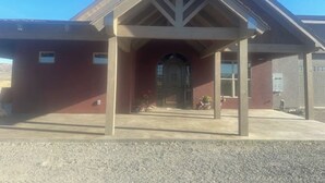 A building with a covered entrance, a red facade, and a sloped roof. - Lake Roosevelt Retreat - Spring Canyon Boat Launch (Grand Coulee)