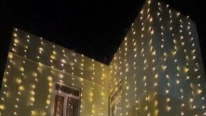 A building with string lights and a water feature. - R J Residency  (Varanasi)