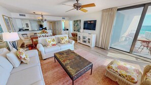 A spacious living area with a sofa set, a coffee table, and a television. - Newly renovated Mainsail 152 - Stunning Views with Free Beach Service for 2 (Miramar Beach)
