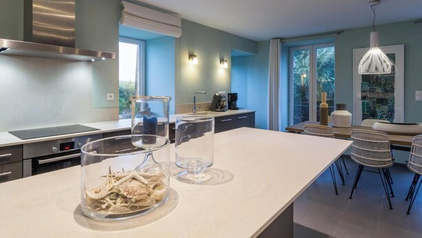 A modern kitchen with a large island, stainless steel appliances, and a view of the outdoors. - Detached house with panoramic view - 8 guests (Portbail)