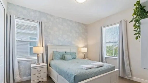 A bedroom with a bed, bedside tables, and curtains. - Last Minute Disney Getaway! Private Pool, Game Room & Themed Bedrooms. Book Now! #170009 (Orlando)