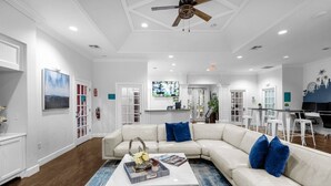 A spacious living room with a white sectional sofa, a coffee table, and a ceiling fan. - Last Minute Disney Getaway! Modern & Comfortable Bedrooms. Book Now! #166509 (Orlando)