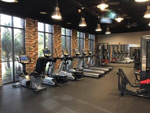 A gym with treadmills, elliptical machines, and weight machines. - Last Minute Disney Getaway! Private Pool & Themed Bedrooms. Book Now! #166597 (Orlando)