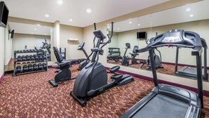 A hotel gym with treadmills, elliptical machines, and dumbbells. - Super 8 by Wyndham Clovis (Clovis)