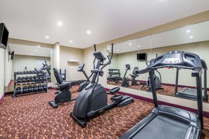A hotel gym with treadmills, elliptical machines, and dumbbells. - Super 8 by Wyndham Clovis (Clovis)