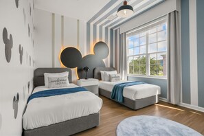 A modern bedroom with two beds, a large window, and a unique wall design. - Last Minute Disney Getaway! Beautiful Townhouse & Private Balcony. Book Now! #172665 (Orlando)