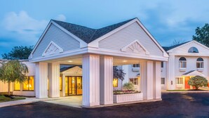 A two-story hotel with a covered entrance, large windows, and a well-maintained exterior. - Days Inn by Wyndham Tiffin (Tiffin)