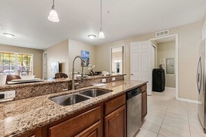 A kitchen with granite countertops, stainless steel appliances, and wooden cabinets. - Prime location·Mins from Epic Universe & I-Drive (Orlando)