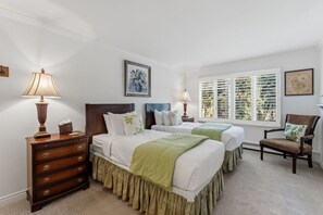 A hotel room with two beds, a dresser, a chair, and a window with blinds. - Creekside Condo in Vail Village I Walk to Gondola (Vail)