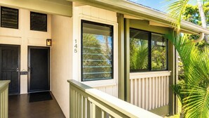 A building with a number '145' on the wall, a door, and a window with blinds. - Kuilima Estates 2 Golf View Villas, Sleeps 16 | Car Incl. w/ 6 Nights | KUL ML-4046 by KBM (Kahuku)