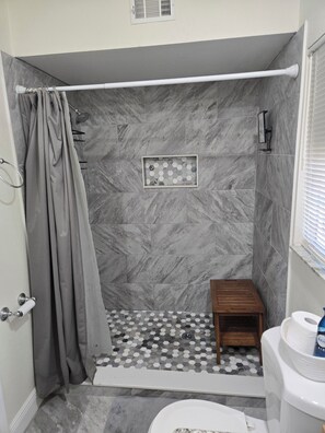 A bathroom with a shower, toilet, and a small wooden stool. - Soothing 3-bedroom house with AC in charming Sorrento (Sorrento)