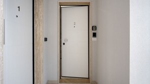 A door with a number '2' on it, a keypad lock, and a small light above the door. - SPA and Relax 2 - Elegant Seaside Studio (Monopoli)
