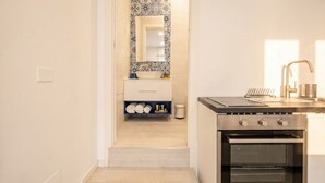 A kitchen with a stove, oven, and a countertop with a sink. - SPA and Relax 2 - Elegant Seaside Studio (Monopoli)