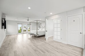 A spacious bedroom with a large bed, a ceiling fan, and a view through the door. - McCarty Mansion - Fort Pierce Waterfront Paradise - 7Br/6Ba - Sleeps 20 (Fort Pierce)