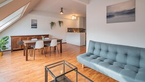 A modern loft apartment with a dining area, a sofa, and a kitchen. - 2 Bedroom Apartment in Antwerp (Antwerp)