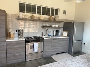 Private kitchen - Designer Loft at Ponce City Market with Natural Light & Murals (atlanta)