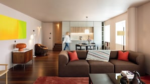 A modern living room with a sectional sofa, a coffee table, and a side table.