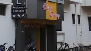 A multi-story building with a sign indicating it is a hotel.