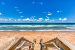 A wooden boardwalk leading to a beach with waves and a clear sky. - Ormond Beach, Ocean View, Balcony, Beach Access (Ormond Beach)