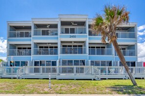 A multi-story hotel with balconies, a palm tree, and a clear sky. - Ormond Beach, Ocean View, Balcony, Beach Access (Ormond Beach)