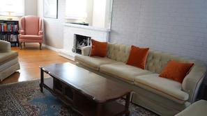 A living room with a sofa, armchair, and coffee table.