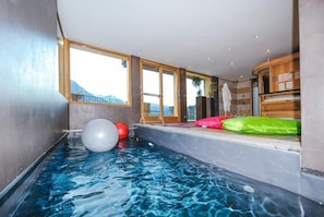 An indoor swimming pool with a view of mountains, exercise balls, and wooden cabinets. - Chalet, Ground floor, balcony, fireplace or stove, tv, ski locker, 380m², Saint Martin de Belleville (Saint-Martin-de-Belleville)