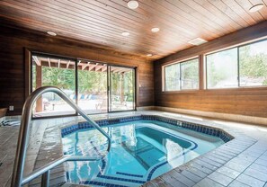 An indoor swimming pool with a wooden ceiling and large windows. - Stylish Alpine Retreat Steps from Slopes & Trails (Park City)