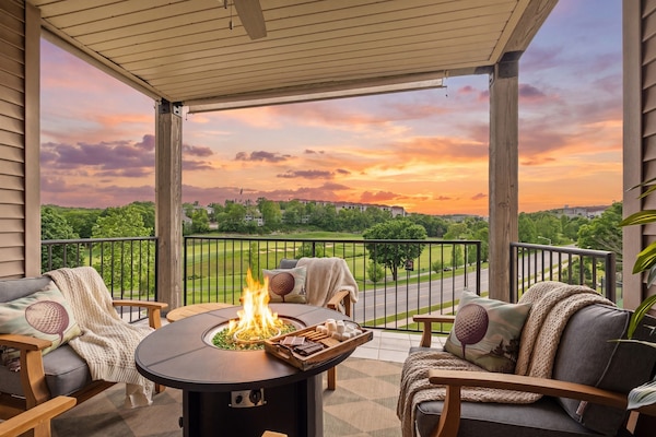 The back patio is perfect for relaxing in the evening and entertaining with comfy chairs and propane fire table