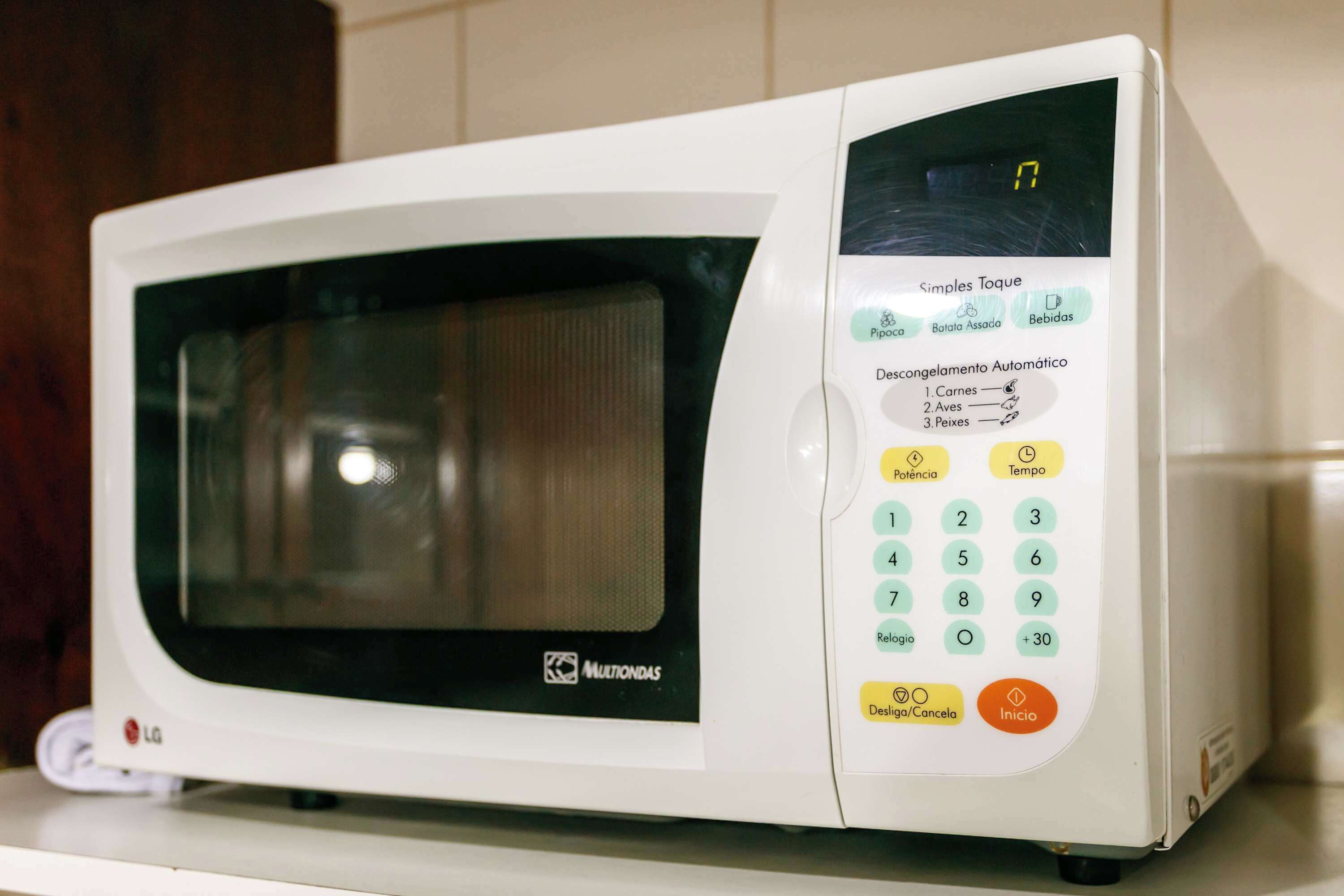 A microwave with a digital display, control panel, and a power button.