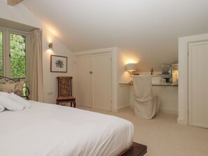 A bedroom with a bed, a chair, a desk, and a wardrobe. - Lower Velwell Barn (Totnes)