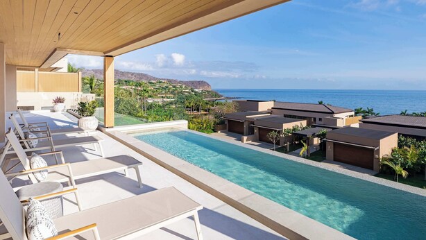 A poolside area with lounge chairs and a view of the ocean. - Costa Azul at Kupuri Beach Residences (Desarrollo Punta Mita)