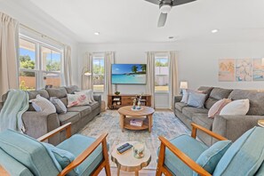 A living room with two sofas, a coffee table, and a TV on the wall. - New Build | <10 Mins to Folly & <15 to DT (Charleston)