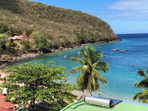 A coastal view with clear turquoise waters, a beach, and a hill with vegetation. - T3 apartment in holiday village - 4/6 persons Sea view & Swimming pool (Rated 3*) (Sainte-Luce)