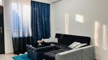 Comfort Apartment, 1 King Bed with Sofa bed, Balcony, City View | Living area | Flat-screen TV