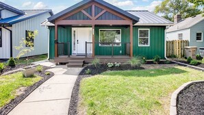 A single-story house with a front porch, a garage, and a small garden area. - Modern 3 bed 4 bath home just 5 mins to ND (1446) (South Bend)