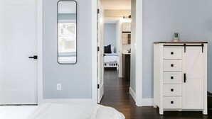 A bedroom with a bed, a dresser, and a mirror on the wall. - Modern 3 bed 4 bath home just 5 mins to ND (1446) (South Bend)