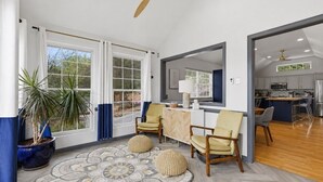 A spacious living area with a large window, a ceiling fan, and a view of the outdoors. - Tremendous 4-bedroom house with Boat Dock, Pool and Hot Tub in charming Harriman (Harriman)