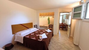 A hotel room with a bed, a desk, and a chair. - Villa Teria, exclusive property! (Santa Maria Navarrese)