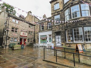 A stone building with a cafe, a deli, and a sign for Beatties. - Stagwood House (Holmfirth)